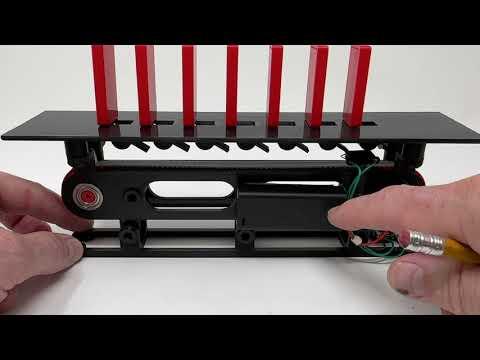 A "Do Nothing" Dominoes Box, How It Works.