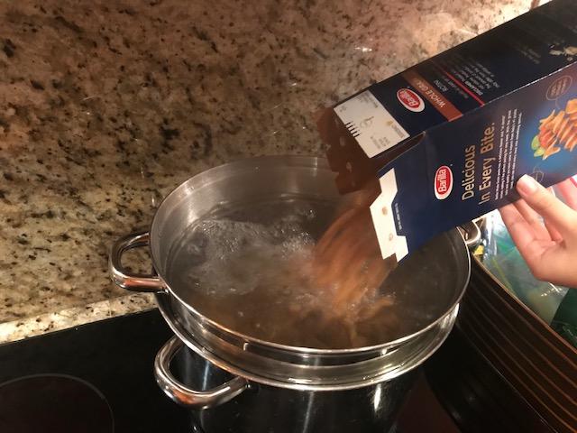 Adding pasta to pot.jpg