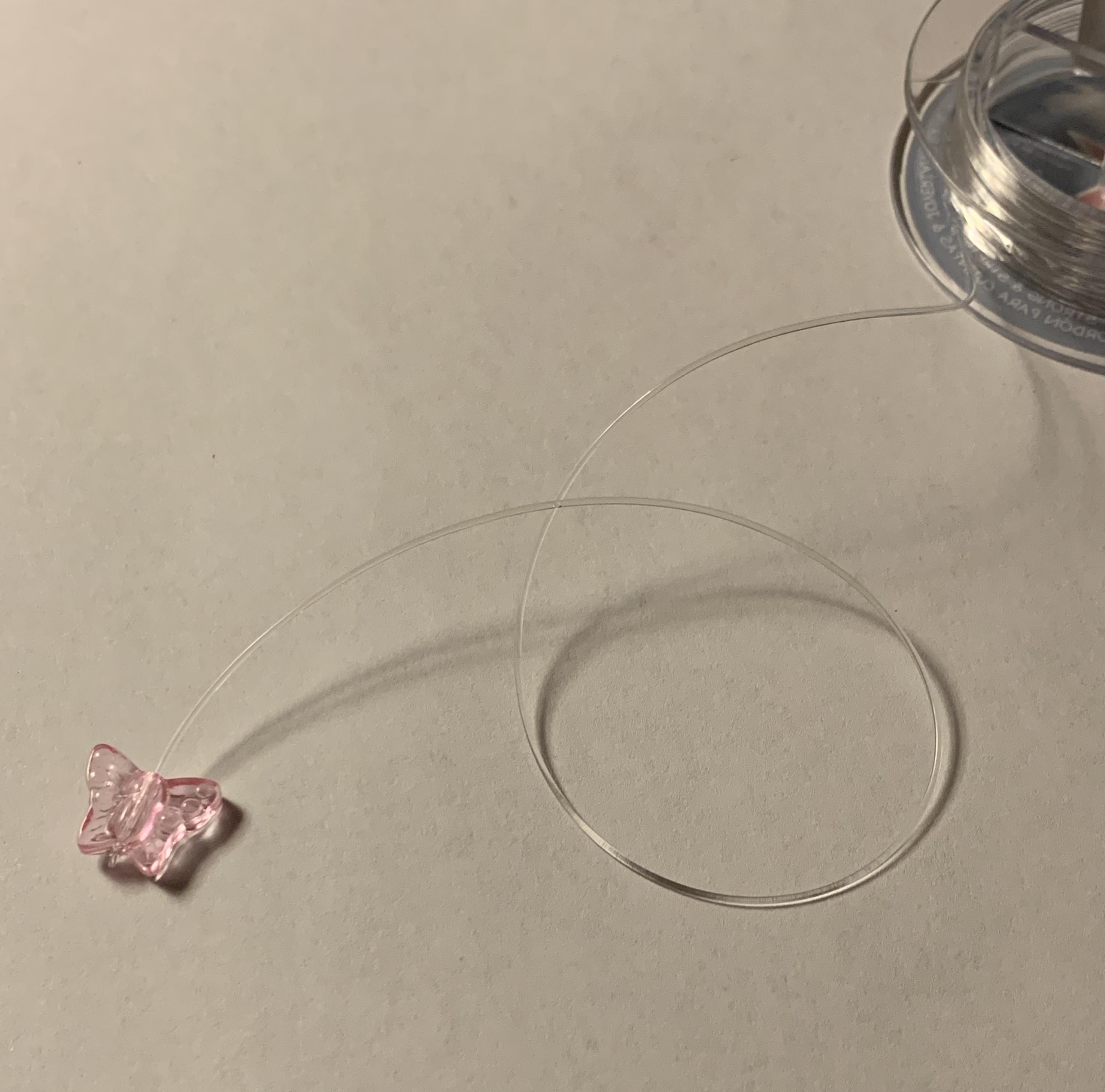 tie a knot below the first bead.jpg