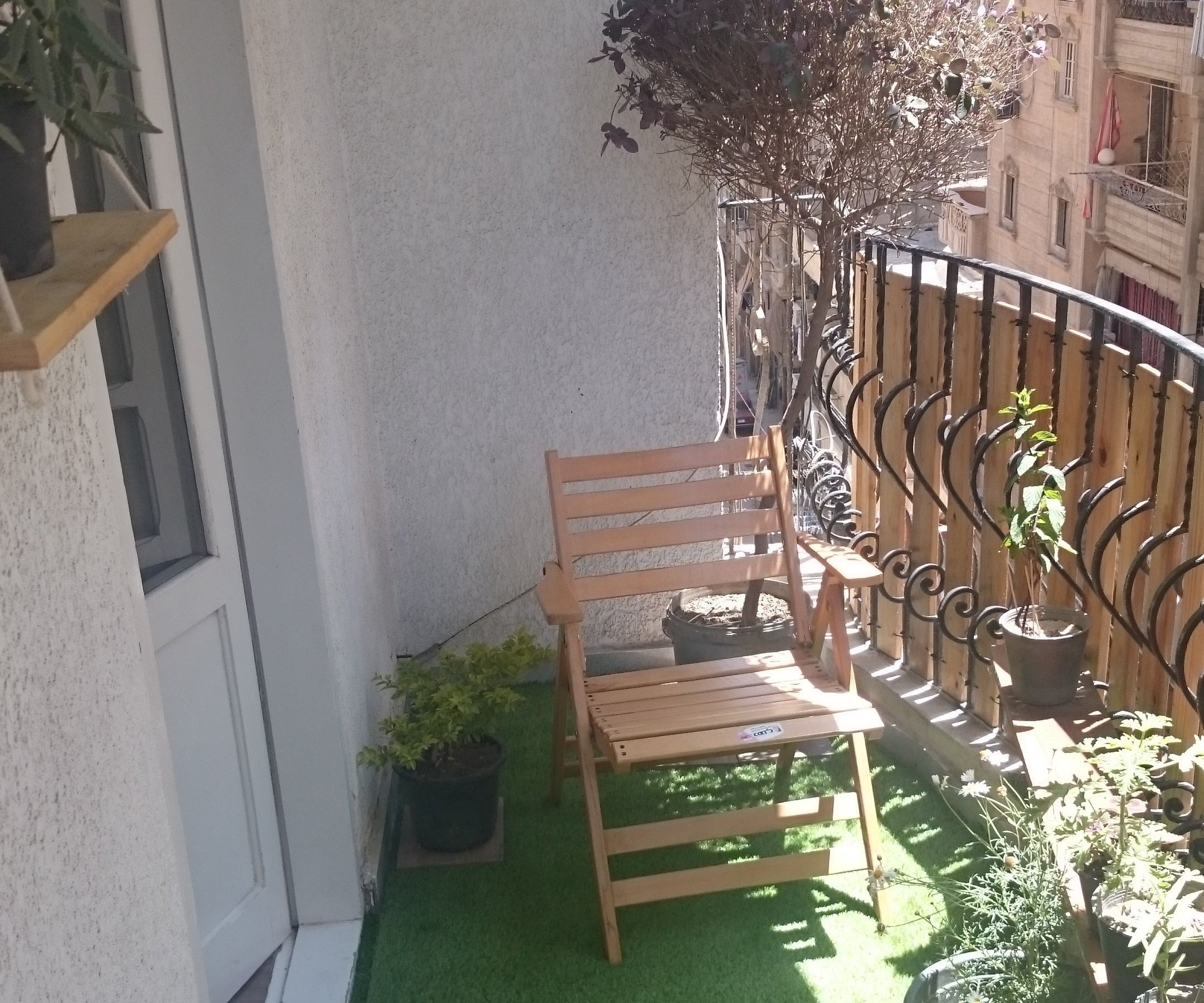 Cozy Balcony by Bring in Greenery and Using Some Rustic Wood. 